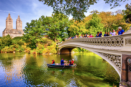 New York, United States - October 7, 2017: people in a boat in Bow Brige, Central Park, at autumn in Manhattan. New York City. USA