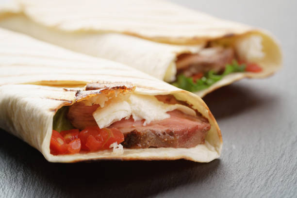 istock burritos with beef steak, corn, black beans on slate board 913696846