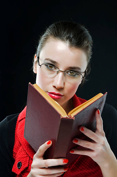 istock beautiful young woman holding book 91370007
