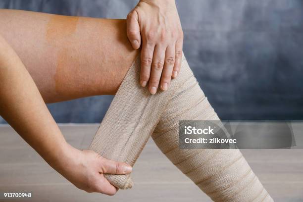 Application Of Elastic Compression Bandage Stock Photo - Download Image Now - Compression Garment, Bandage, Leg