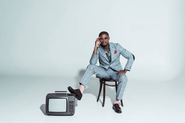 istock Stylish posing on wooden chair 913704716