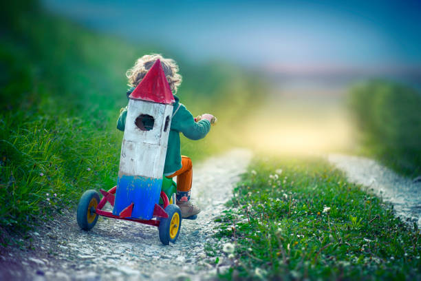 Child With Toy Space Rocket and Tricycle Child Imagination super bike stock pictures, royalty-free photos & images