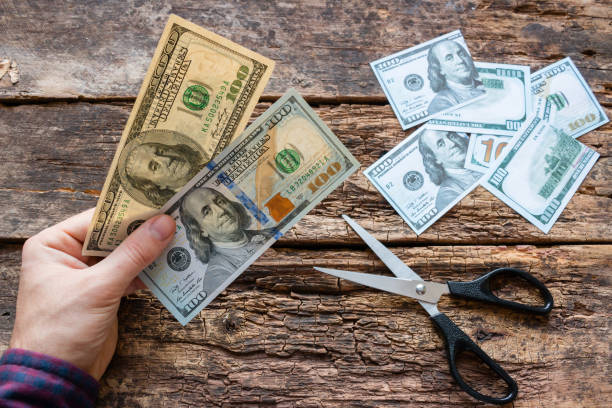 istock man shows different banknotes of American dollars 913705360