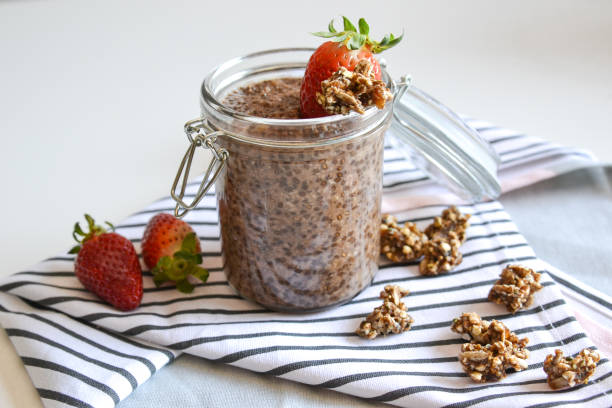 Chocolate homemade chia pudding with granola and strawberry