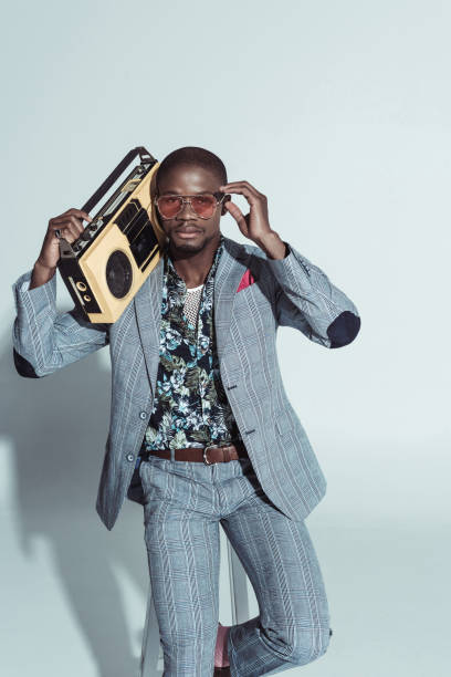 istock Fashionable man holding boombox 913707944