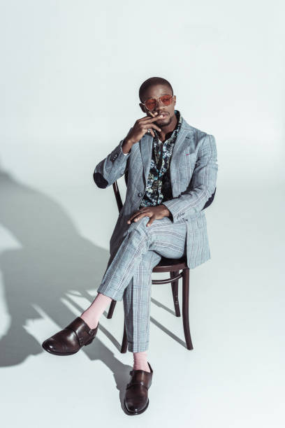 istock african american man sitting on chair 913708468