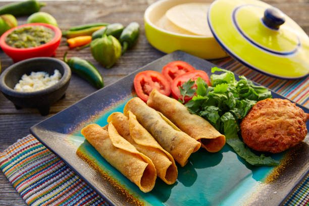 istock Mexican flautas rolled tacos with salsa 913709152