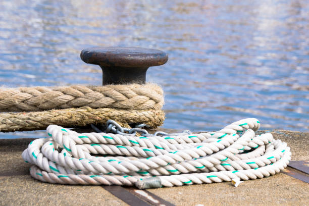 istock Ship mooring ropes secured around a port bollard 913709518