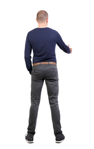 Back side view of man  in shirt handshake. Back side view of man  in shirt handshake.  Rear view people collection.  backside view of person.  Isolated over white background. a shortly cropped man in trousers pushing his hand in his pocket stretches out the second for greetings estrechar las manos stock pictures, royalty-free photos & images