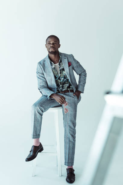 istock Fashionable african american man on bar stool 913709718