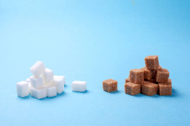 istock White and brown sugar cane sugar cubes on a blue background. Copy space for text 913709942