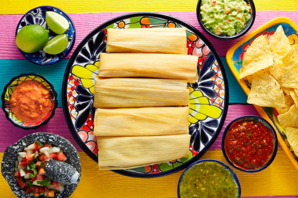istock Tamale with corn leaf and sauces guacamole 913710316