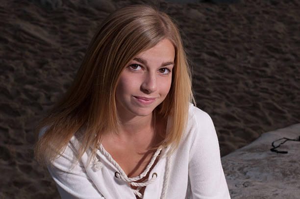 Young lady smiles mysteriously for camera stock photo