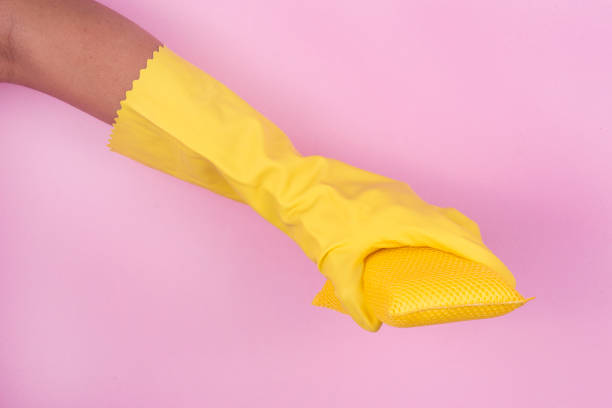 istock Hand in yellow protective glove cleaning with rag 913714226