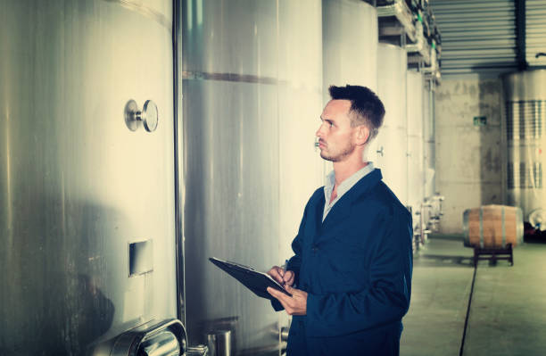 istock Portrait of  man wearing coat taking off data from equipment 913714542