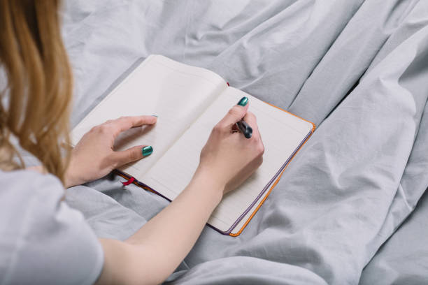 istock cropped image of girl writing something to notebook 913717828