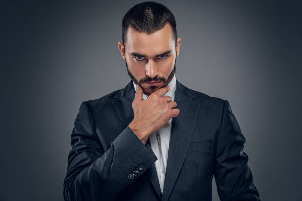 istock A man in a suit isolated on grey background. 913721142