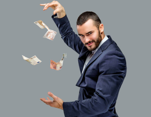 istock Bearded male in a suit holding cash. 913722426