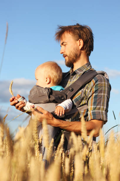 istock father shows his son the ear of barley, vertical frame, vertical 913722598