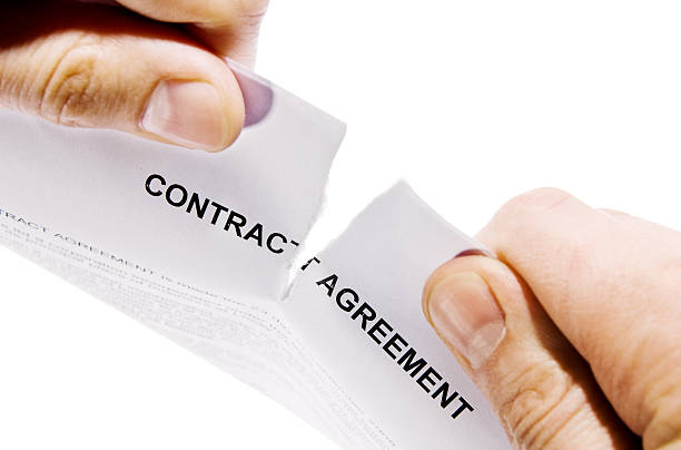 Hands ripping contract agreement document stock photo