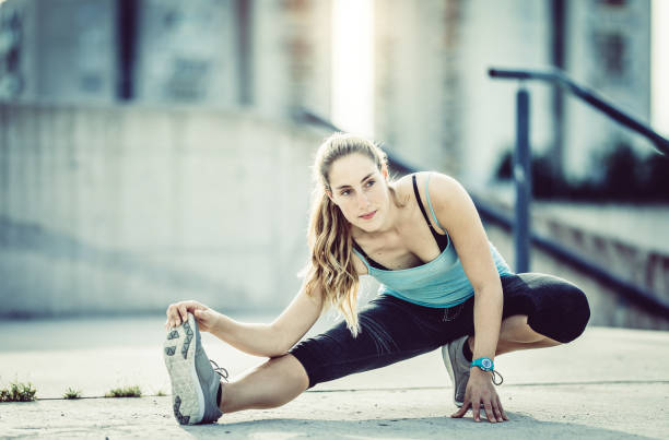 istock Female Athlete Stretching Outdoors 913726446