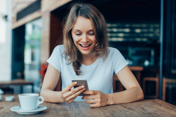 istock Excited Lady Using Smartphone in Outdoor Cafe 913727478