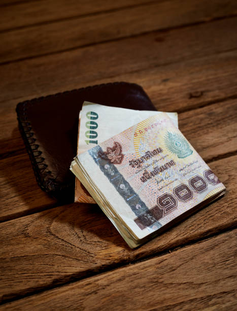 istock brown leather wallet and Thai money 913730128