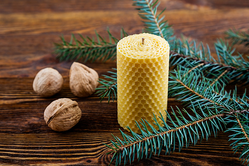 Candle made of natural wax on a wooden background