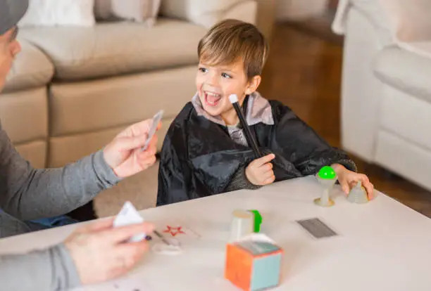 Grandpa Magician entertains his grandson, fun family time