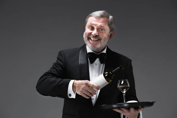 istock professional waiter in uniform is serving wine 913735670
