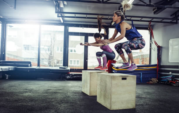 istock Fitness woman doing box jump workout at gym. 913740100