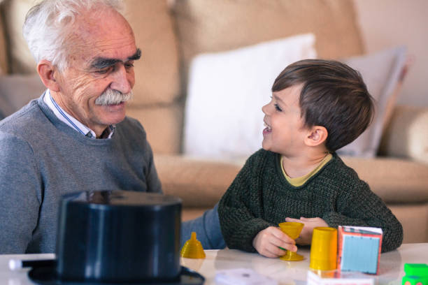 istock Grandfather playing magic with his grandson 913740150