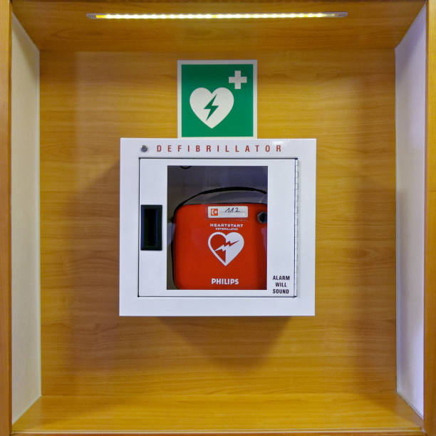 Defibrillator Zirndorf, Germany - January 31, 2018: Red heartstart external Defibrillator hangs on a wooden wall in a white box in a restaurant in Germany, Zirndorf. defibrillator photos stock pictures, royalty-free photos & images