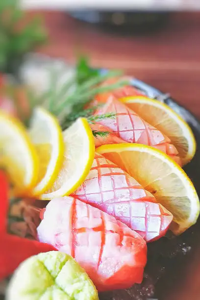 There are otoro (tuna fish), yellow lemon, white daikon radish put on ice to preserve freshness.