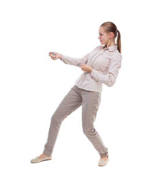 back view of standing girl pulling a rope from the top or cling