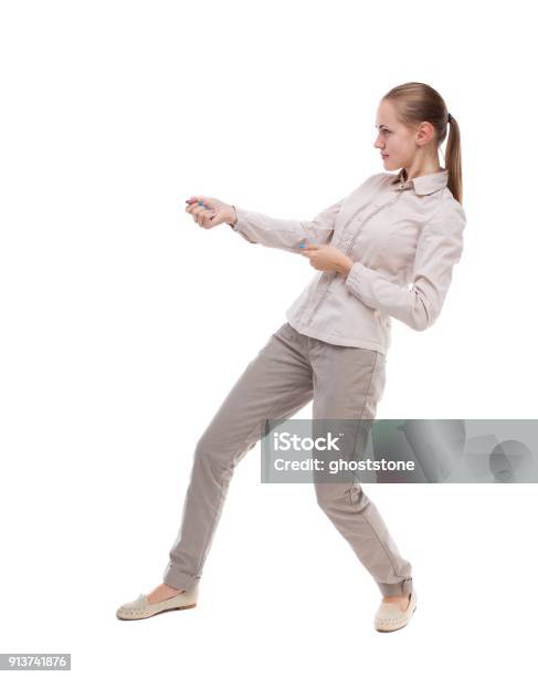 Back View Of Standing Girl Pulling A Rope From The Top Or Cling Stock Photo - Download Image Now