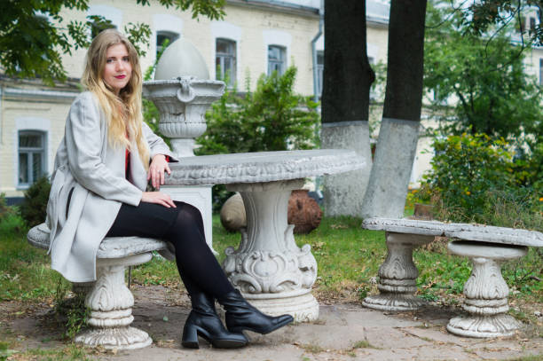 istock Young pretty girl in the old park 913756846