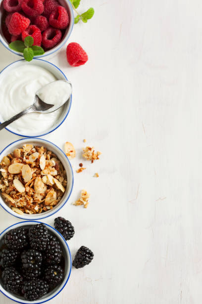Homemade granola with yogurt and berry Homemade granola with yogurt and berry parfait photos stock pictures, royalty-free photos & images