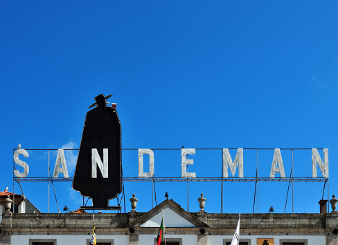 Vila Nova de Gaia, Portugal: Sandeman Port wine company building - waterfront avenue (Av. de Diogo Leite) - the brand's iconic logo features a caped man named Don, designed in 1928 by George Massiot Brown