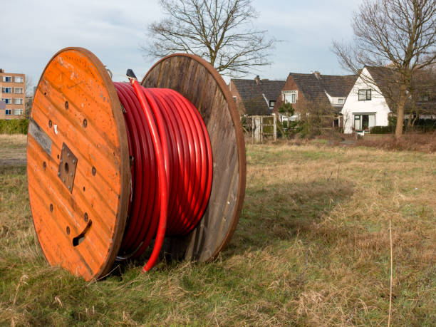 istock High voltage distribution cable reel on grass in residential area 913759934