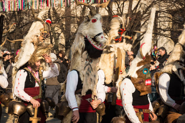 Pernik, Bulgaria - January 27, 2018: People (Kukeri) in the festival of the Masquerade Games Surova in Pernik, Bulgaria. Kukeri are elaborately costumed Bulgarian people who perform traditional rituals intended to scare away evil spirits.