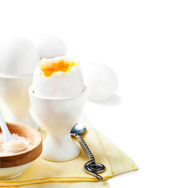 istock Boiled egg with pink salt for breakfast isolated on white background 913759942