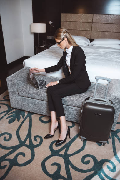 istock businesswoman using laptop in hotel room 913762566