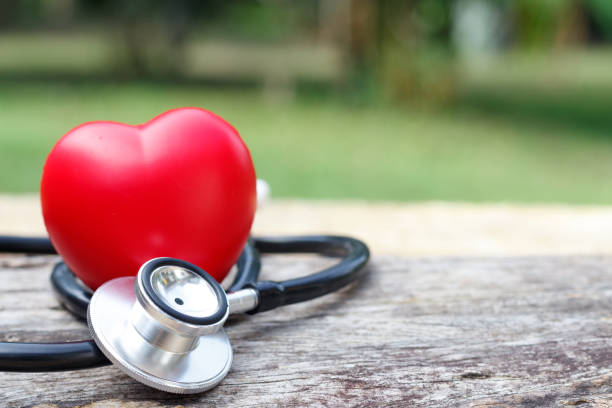 istock Red heart and a stethoscope on wooden background. 913765690