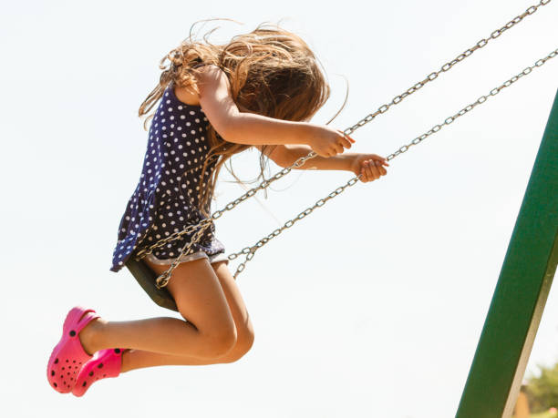 istock Girl swinging on swing-set. 913765888