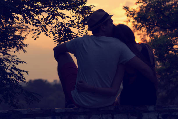 couple in love. love concept. - silhouette kissing park sunset imagens e fotografias de stock