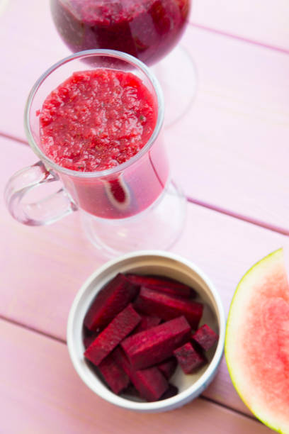 istock Smoothie on pink wooden background 913773572