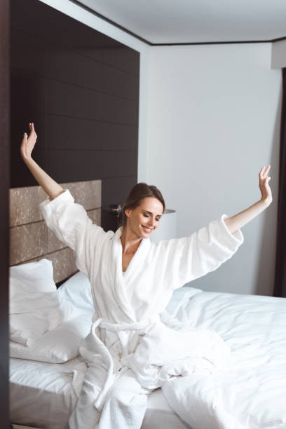 istock woman waking up in hotel room 913777358
