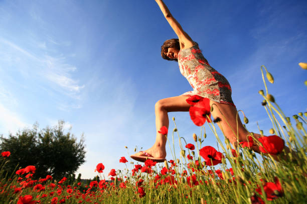 istock woman in the fields of poppies 913778182