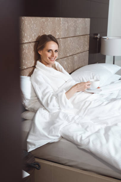 istock woman in bathrobe drinking coffee 913778254